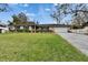 Charming one-story home with a manicured lawn, brick exterior, and attached two-car garage at 4523 Hallamview Ln, Lakeland, FL 33813