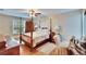 This main bedroom is well-lit, featuring a ceiling fan and large windows at 4523 Hallamview Ln, Lakeland, FL 33813