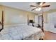 The main bedroom is cozy with a patterned quilt and ceiling fan at 4523 Hallamview Ln, Lakeland, FL 33813