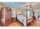 Well-lit main bedroom with ceiling fan, hardwood floors, and a view of the ensuite bathroom at 4523 Hallamview Ln, Lakeland, FL 33813