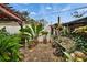 Tranquil patio adorned with potted plants, brick pavers, and a wooden pergola, offering a peaceful outdoor setting at 4523 Hallamview Ln, Lakeland, FL 33813