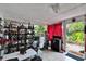 Bright sunroom with tile floors, red curtains, and shelves filled with decorative items at 4523 Hallamview Ln, Lakeland, FL 33813