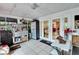 Bright sunroom with white tile flooring, a workbench and ample storage at 4523 Hallamview Ln, Lakeland, FL 33813