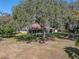 House with screened porch, large backyard, and mature oak trees with Spanish moss at 465 Rowland Ct, Bartow, FL 33830