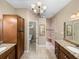 Spa-like bathroom with double sinks, granite vanity, and a walk-in shower at 465 Rowland Ct, Bartow, FL 33830