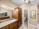 Elegant bathroom with granite countertop, double sinks, and separate toilet area at 465 Rowland Ct, Bartow, FL 33830