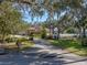 Long driveway leading to a charming house nestled amongst trees at 465 Rowland Ct, Bartow, FL 33830