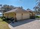 Two-car garage with paver driveway and backyard view at 465 Rowland Ct, Bartow, FL 33830