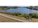 Lakefront property with grassy area and sidewalk at 465 Rowland Ct, Bartow, FL 33830