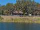 Picturesque view of the house from across the lake at 465 Rowland Ct, Bartow, FL 33830