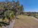 Picturesque lakefront view with lush landscaping at 465 Rowland Ct, Bartow, FL 33830