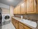 Laundry room with sink, cabinets, and built-in storage at 465 Rowland Ct, Bartow, FL 33830