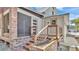 Back porch with brick foundation, wood railing, and screened-in sitting area at 520 E Stanford St, Bartow, FL 33830