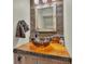 Unique bathroom vanity with a vessel sink, rustic wood counter, and decorative mirror at 520 E Stanford St, Bartow, FL 33830