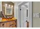 Stylish bathroom vanity features vessel sink, rustic wood counter, and decorative mirror at 520 E Stanford St, Bartow, FL 33830