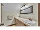 Bathroom with double vanity, neutral color palette, updated fixtures and a framed mirror at 520 E Stanford St, Bartow, FL 33830