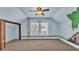 Attic bedroom with blue walls, charming decor and a window with a view at 520 E Stanford St, Bartow, FL 33830