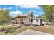 Rear view of this quaint home featuring a wooden porch, brick steps, and a fenced yard at 520 E Stanford St, Bartow, FL 33830