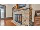 Close up of the beautiful brick fireplace with steel grate and wood mantle and a TV above at 520 E Stanford St, Bartow, FL 33830