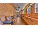 Bright living room with wood paneled walls, lots of natural light, and a rustic aesthetic at 520 E Stanford St, Bartow, FL 33830