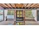 Inviting outdoor patio featuring brick walls, stained glass, fireplace and exposed ceiling with ceiling fan at 520 E Stanford St, Bartow, FL 33830