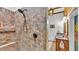 Beautiful tiled stand up shower with a rainfall showerhead and built in shelves plus a view to the vanity at 520 E Stanford St, Bartow, FL 33830