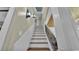 Elegant staircase with white wainscoting and decorative iron railings at 520 E Stanford St, Bartow, FL 33830