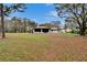 Expansive backyard highlighting the home's rear exterior and the screened-in sunroom at 7929 Chase Rd, Lakeland, FL 33810