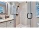 Bathroom featuring a tiled shower with glass door, granite countertops, and modern fixtures at 7929 Chase Rd, Lakeland, FL 33810