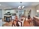 Open-concept dining area with wooden table, chairs, and view into the kitchen at 7929 Chase Rd, Lakeland, FL 33810