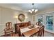 Elegant dining room with hardwood floors, chandelier, and ample seating for guests at 7929 Chase Rd, Lakeland, FL 33810