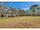 Wide view of the house set back on a large lot with mature trees, offering privacy at 7929 Chase Rd, Lakeland, FL 33810