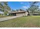 Charming single-story home featuring an attached garage, mature landscaping, and a well-maintained lawn at 7929 Chase Rd, Lakeland, FL 33810