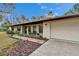 Charming single-story home with a brick walkway, attached garage, and a cozy front bench at 7929 Chase Rd, Lakeland, FL 33810