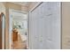 Hallway showing closet and entryway to bedroom with wood floors, a closet, and soft, neutral paint at 7929 Chase Rd, Lakeland, FL 33810