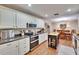 Modern kitchen featuring white cabinets, stainless steel appliances, and adjacent dining area at 7929 Chase Rd, Lakeland, FL 33810