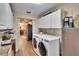 Laundry room with modern washer and dryer adjacent to the kitchen at 7929 Chase Rd, Lakeland, FL 33810