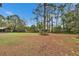 Wide lot featuring mature trees, outbuildings, and a large, open grassy space at 7929 Chase Rd, Lakeland, FL 33810