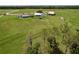 Expansive aerial view showcasing multiple homes on large, lush lots, providing a sense of privacy and serene country living at 1040 Timbers Dr, Fort Meade, FL 33841