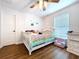 Bright bedroom features a cheerful crib, a window for natural light, and a clean, modern design at 1040 Timbers Dr, Fort Meade, FL 33841