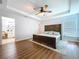 Primary bedroom with a ceiling fan, wood-look floors, and attached bathroom at 1040 Timbers Dr, Fort Meade, FL 33841