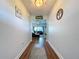 Hallway view towards living room, highlighting wood flooring and the home's open layout at 1040 Timbers Dr, Fort Meade, FL 33841