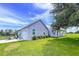 View of the house, golf cart and garage showcasing the exterior features and ample parking space at 1040 Timbers Dr, Fort Meade, FL 33841