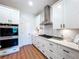 Well-equipped kitchen features sleek white cabinets, stainless steel appliances, and ample counter space for meal preparation at 1040 Timbers Dr, Fort Meade, FL 33841
