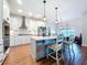 Modern kitchen featuring white cabinets, an island with seating, and stainless steel appliances at 1040 Timbers Dr, Fort Meade, FL 33841
