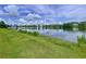 Scenic pond view featuring a calm lake, lush greenery, and a picturesque skyline, perfect for enjoying nature at 1040 Timbers Dr, Fort Meade, FL 33841