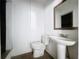 Bathroom with a pedestal sink, toilet and mirror at 105 Old Connersville Rd, Bartow, FL 33830