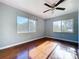 An empty bedroom featuring two large windows and hardwood floors at 105 Old Connersville Rd, Bartow, FL 33830