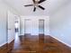Spacious bedroom featuring hardwood floors, neutral paint, a ceiling fan, and convenient closet space at 105 Old Connersville Rd, Bartow, FL 33830
