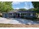 Charming single-story home with blue accents and a large driveway at 105 Old Connersville Rd, Bartow, FL 33830